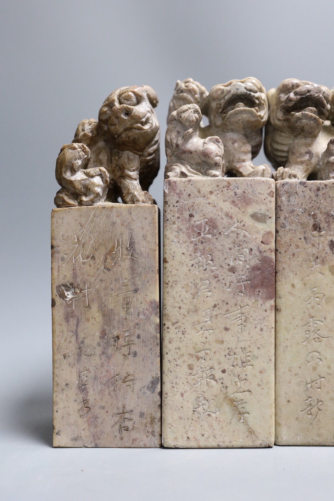 Two pairs of Chinese carved soapstone ‘lion dog’ seals and similar cups, tallest 19cm